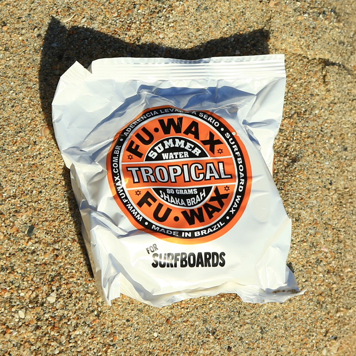 FU Wax Summer Tropical bar in its wrapper on the sand